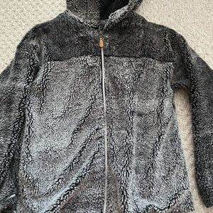 Medium, long sleeve black and grey sherpa jacket.